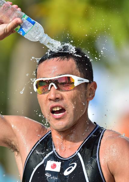 Incheon 2014. Il giapponese Hirokatsu Tayama si rinfresca durante la frazione a piedi della gara di triathlon (Afp)